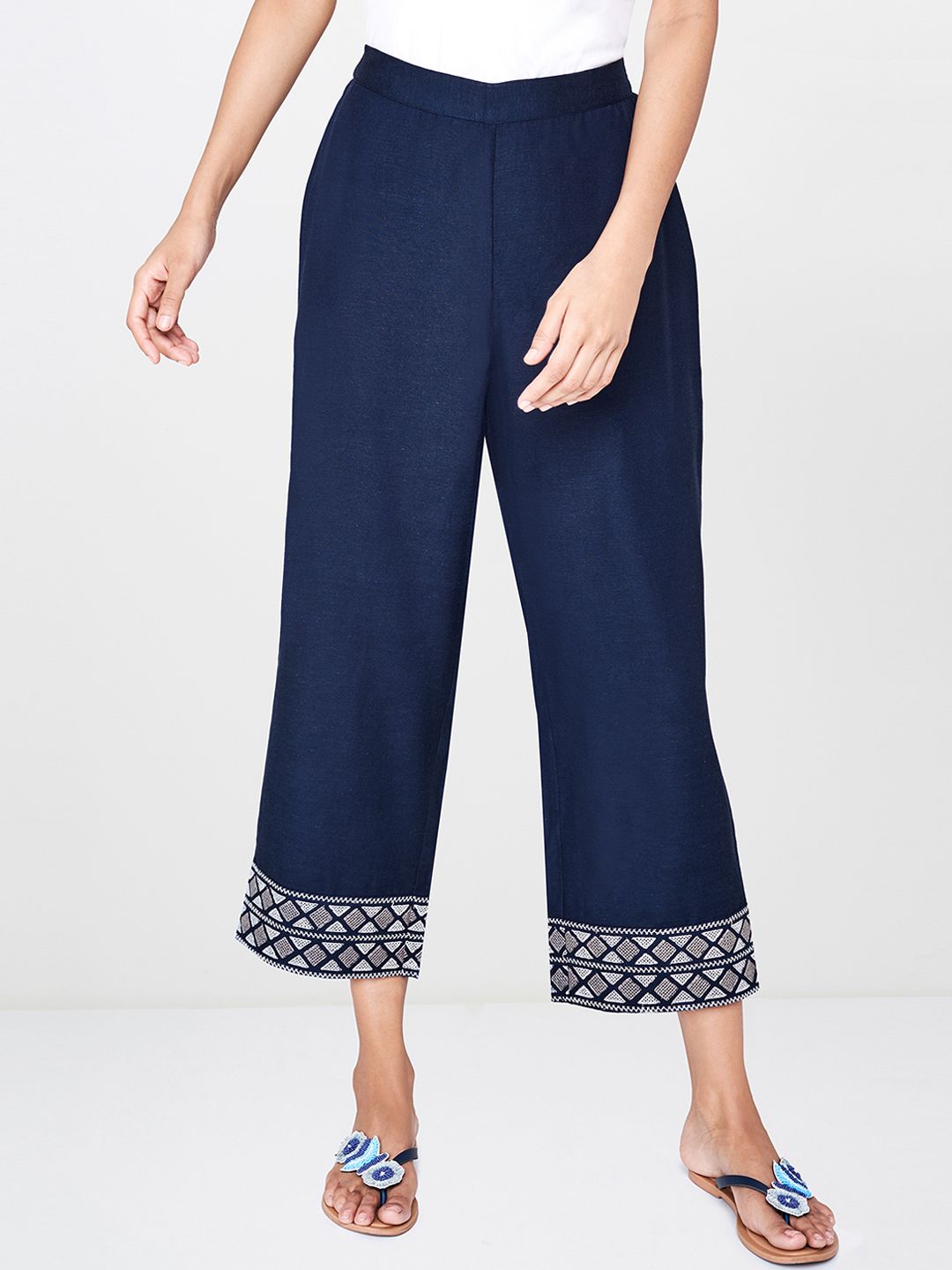 Global Desi Women Navy Blue Relaxed Fit Solid Regular Trousers With Embroidered Hem Price in India