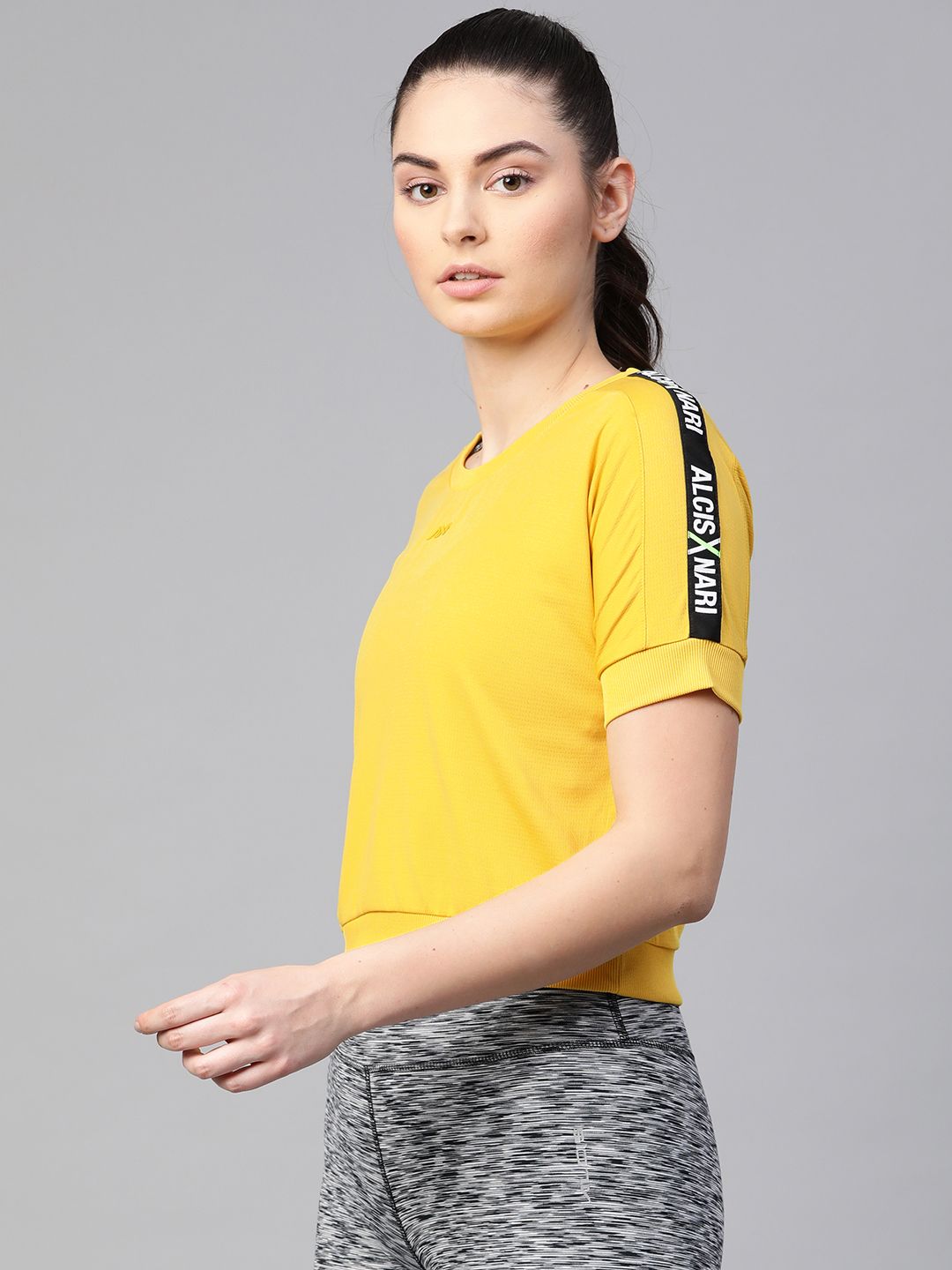 Alcis Women Yellow & Black Solid Round Neck T-shirt with Applique Detail Price in India