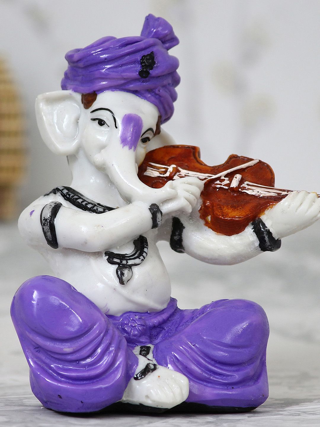 eCraftIndia Off-White & Purple Handcrafted Lord Ganesha Playing The Violin Idol Price in India