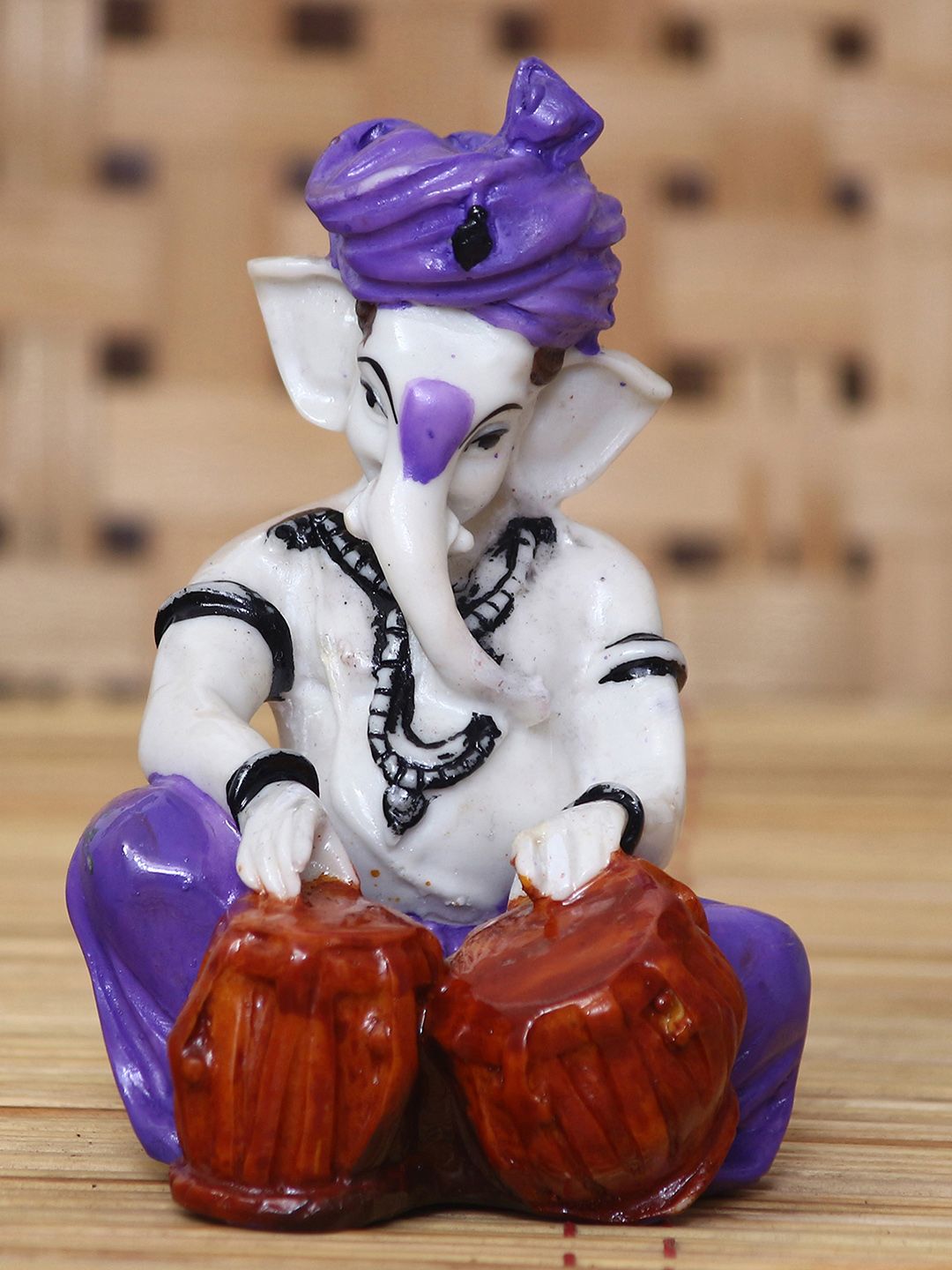 eCraftIndia White & Purple Handcrafted Lord Ganesha Playing Tabla Idol Price in India