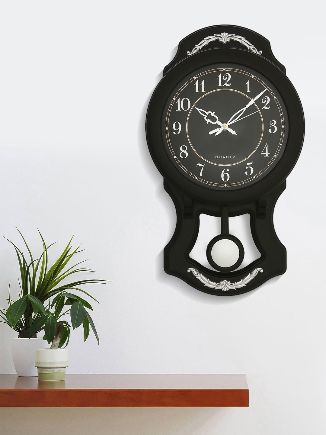 eCraftIndia Black & Silver-Toned Quirky Solid 26 x 44 CM Analogue Wall Clock Price in India
