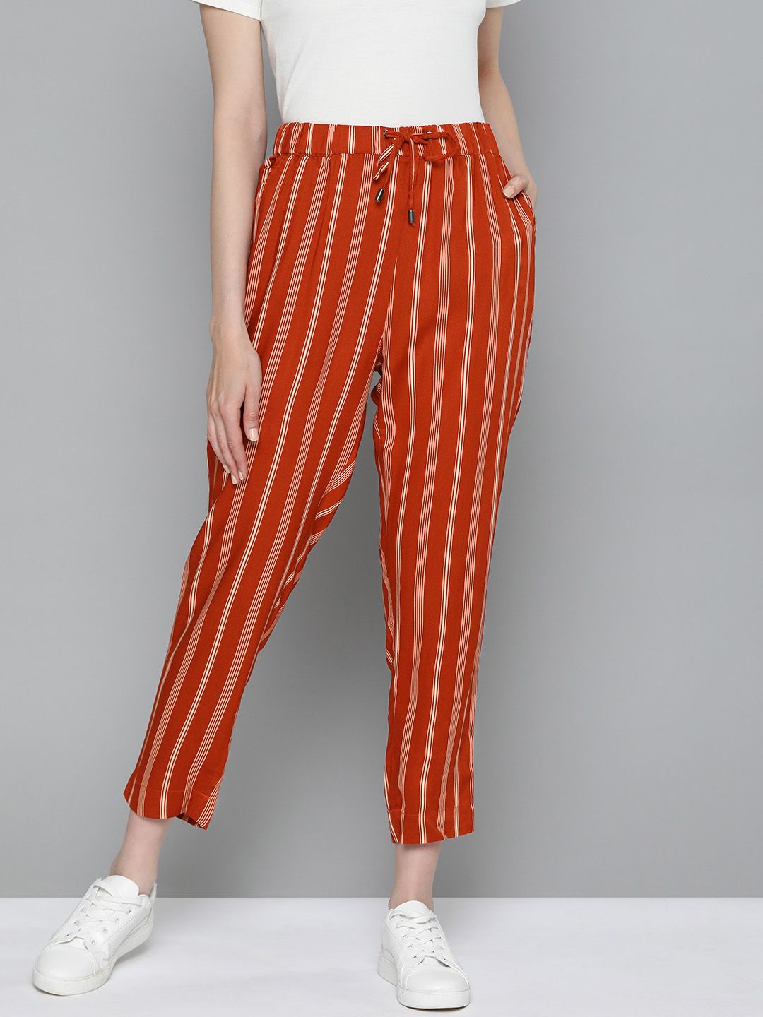 Chemistry Women Rust Orange & Off White Striped Ankle Length Trousers Price in India