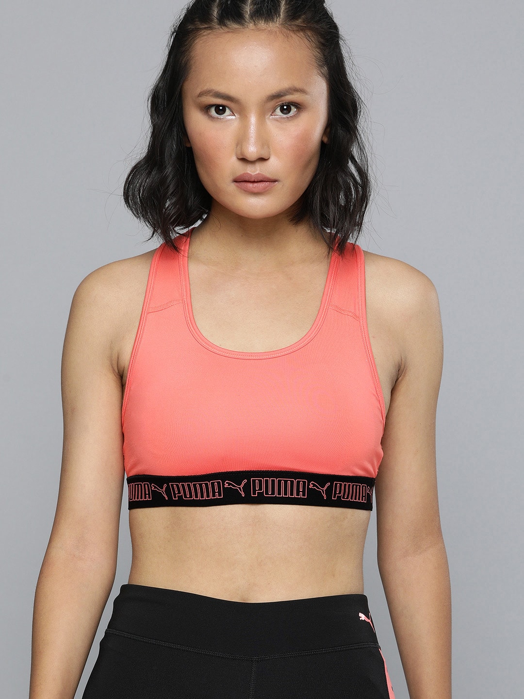 Puma Peach-Coloured Solid Mid Impact Non-Wired Removable Padding Elastic Workout Bra Price in India