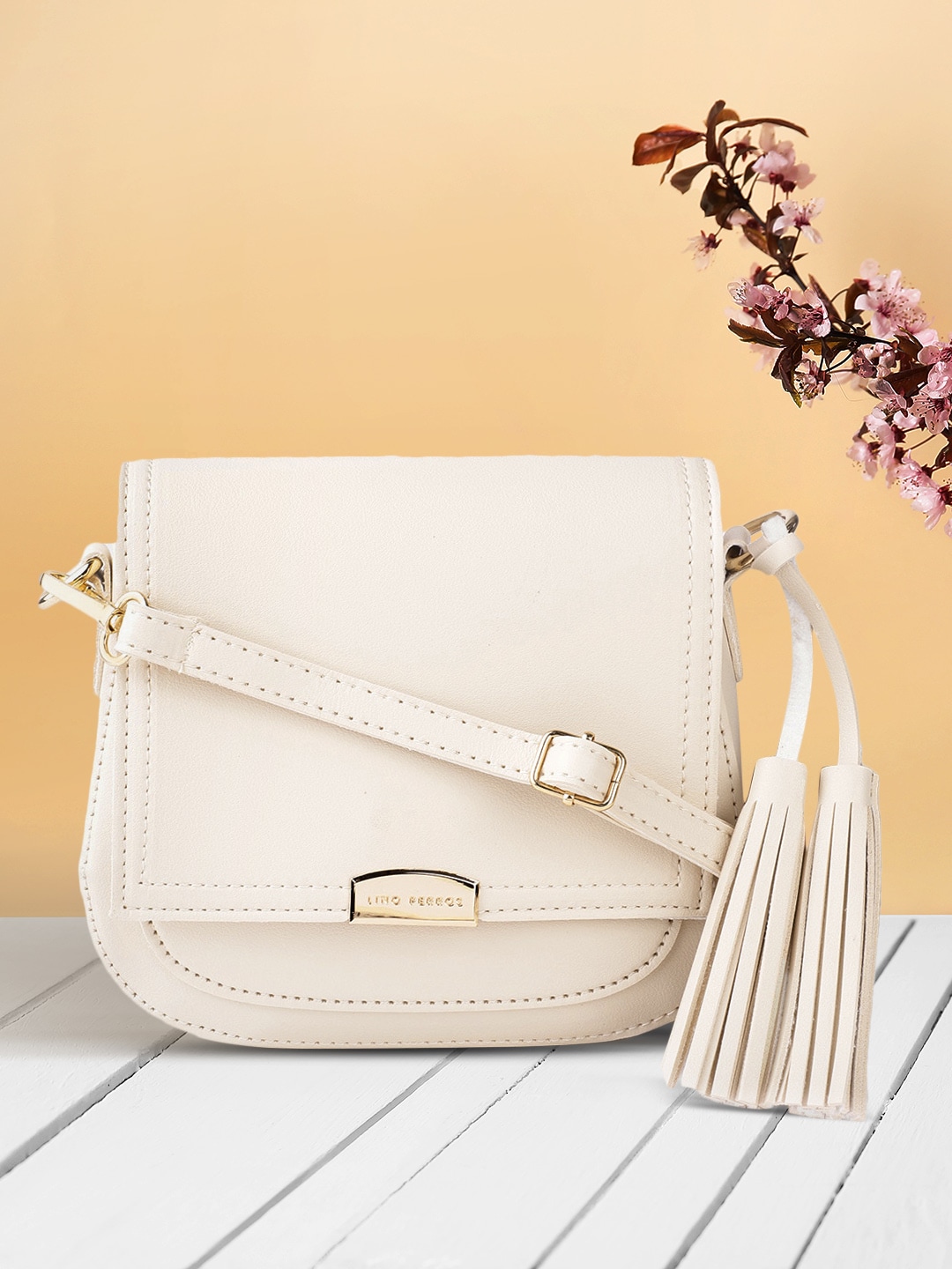 Lino Perros Women Cream-Coloured Solid Sling Bag with Tasselled Detail Price in India