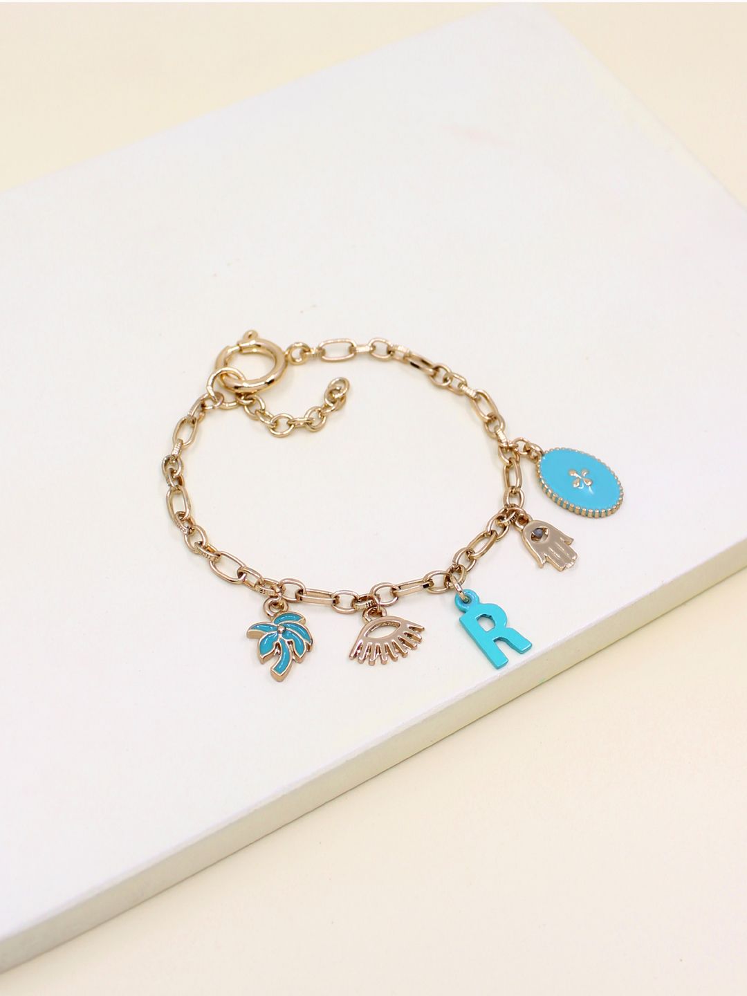 Runway Ritual Gold-Toned Bracelet Handcrafted Alphabet- R Charm Bracelet Price in India
