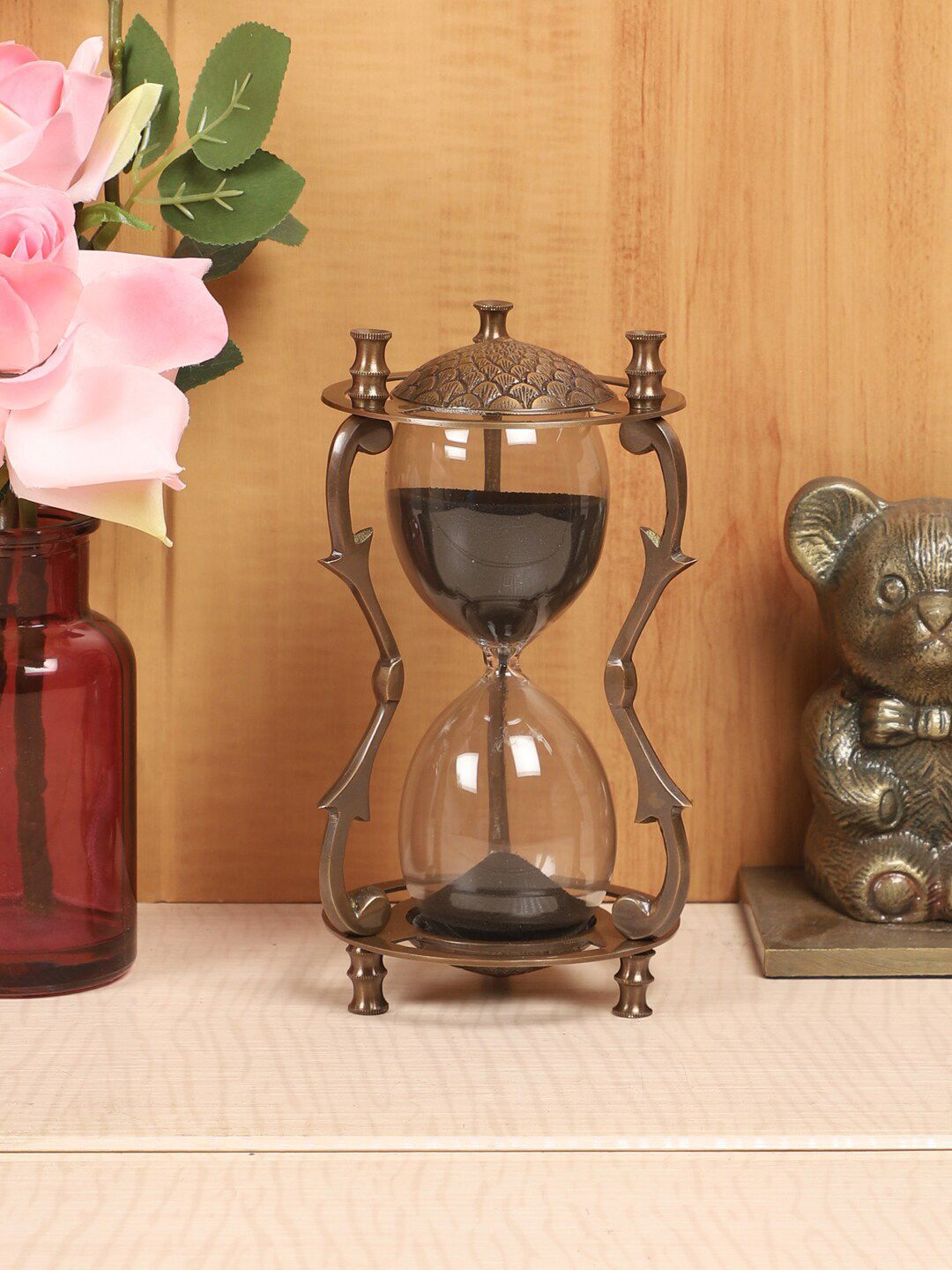 EXIM DECOR Black & Brown Antique Carving Sand Timer With Twigs Pillar Showpiece Price in India