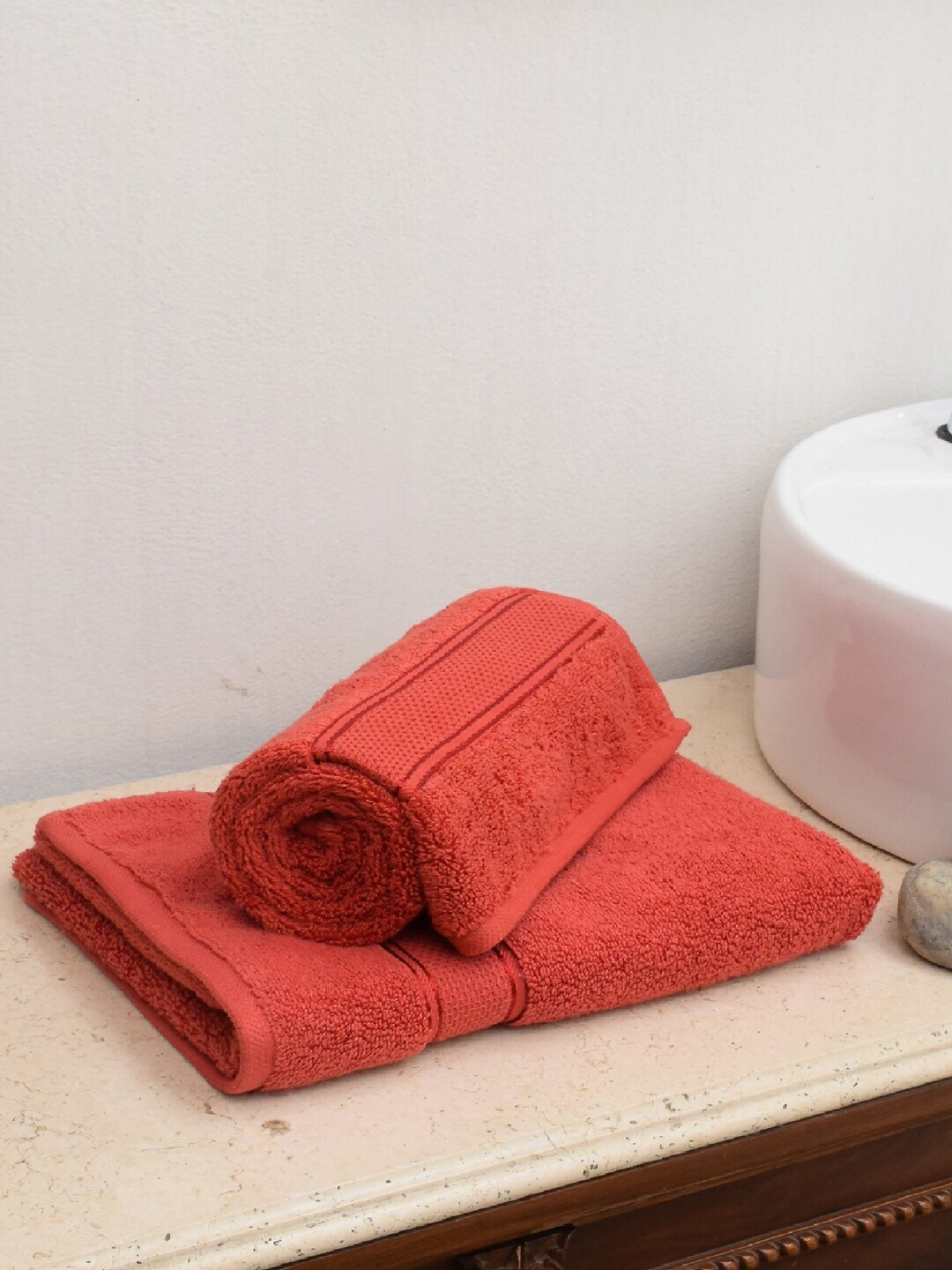 AVI Living Set Of 2 Orange Solid 600 GSM Cotton Hand Towels Price in India