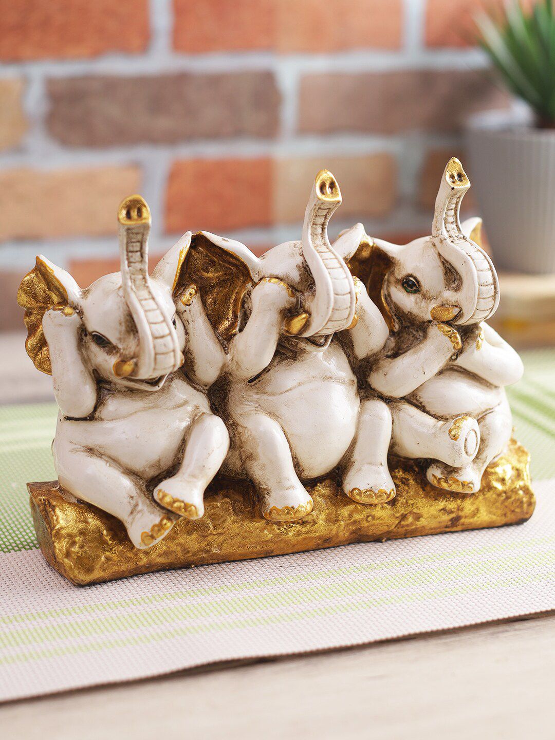 CraftVatika Beige & Gold-Toned Elephant Trunk Up Showpiece Price in India