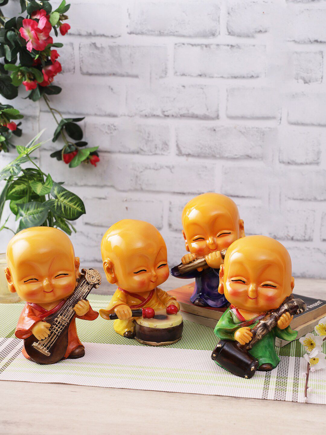 CraftVatika Orange 4-Pieces Musical Monk Buddha Showpiece Set Price in India