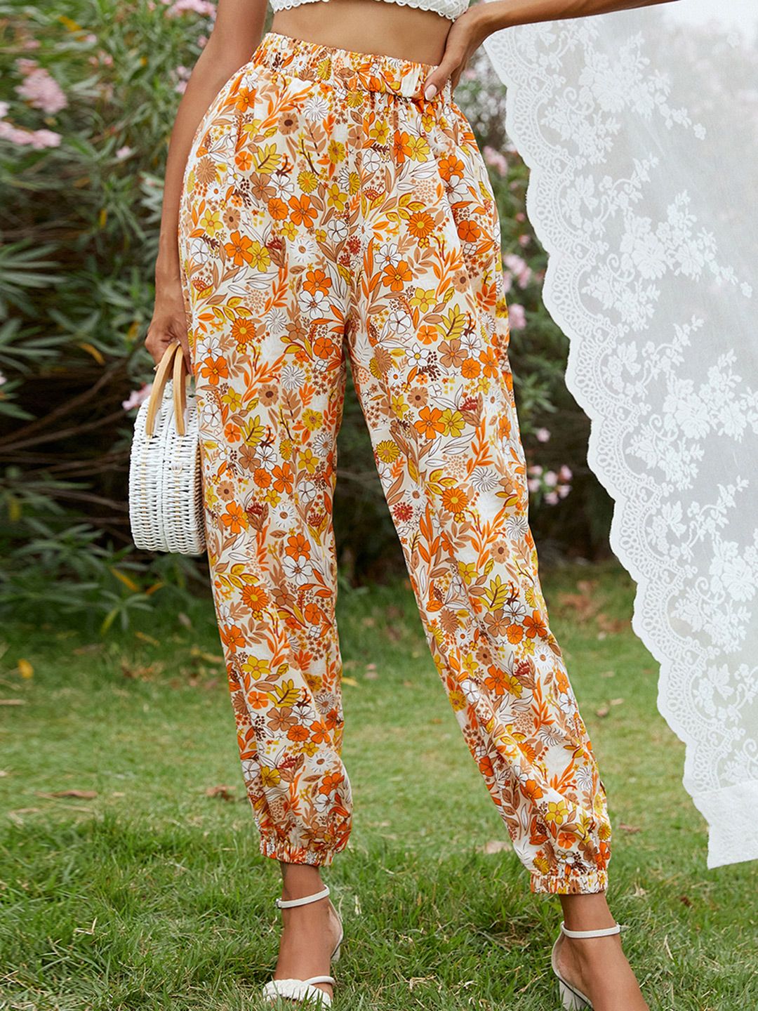 URBANIC Women White & Orange Floral Print Relaxed Fit Trousers Price in India