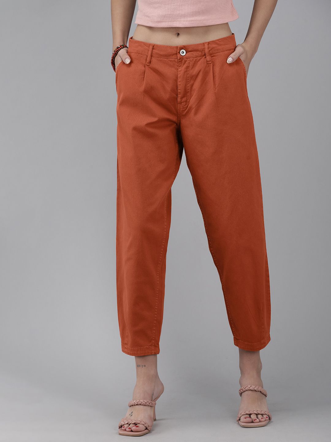The Roadster Lifestyle Co Women Rust Orange Printed Slouchy Fit Cropped Regular Trousers Price in India