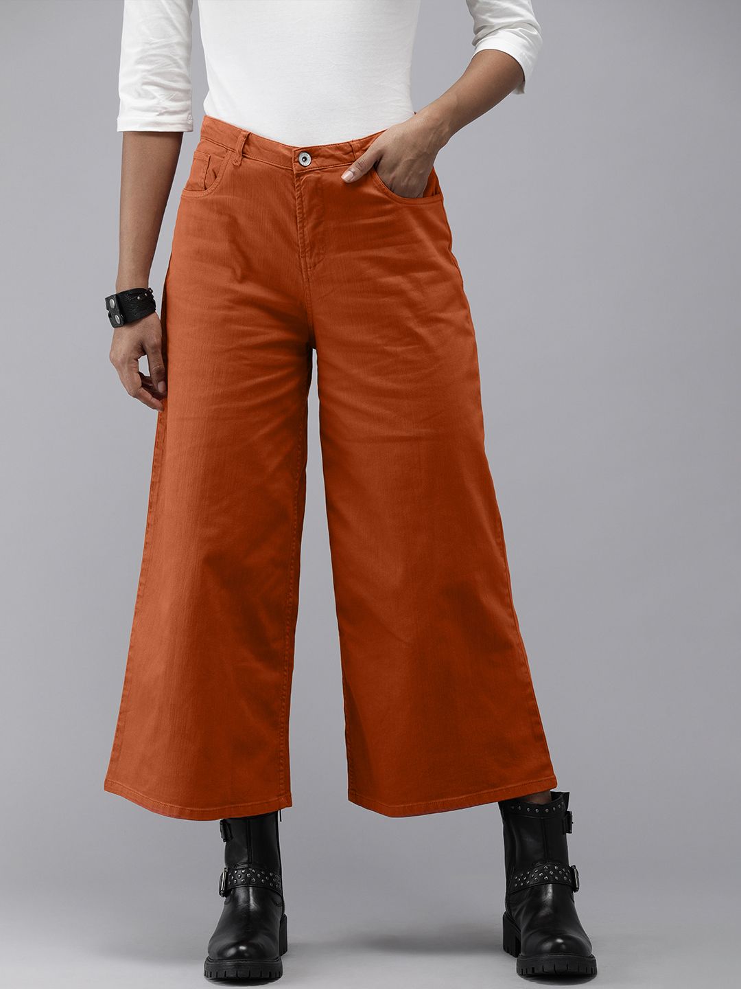 Roadster Women Rust Solid Mid Rise Flared Trousers Price in India
