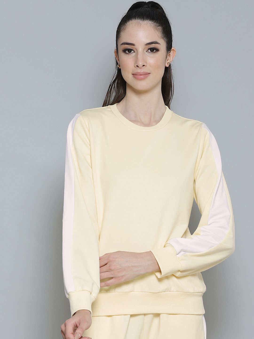 Femella Women Yellow Solid Sweatshirt Price in India