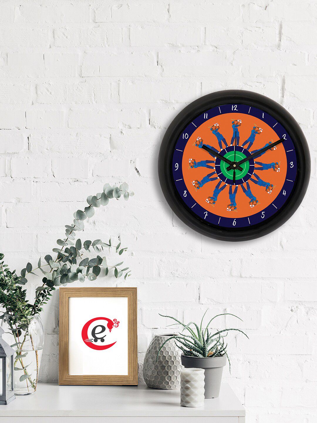 eCraftIndia Orange & Blue Cricket Theme Printed Contemporary Analogue Wall Clock Price in India