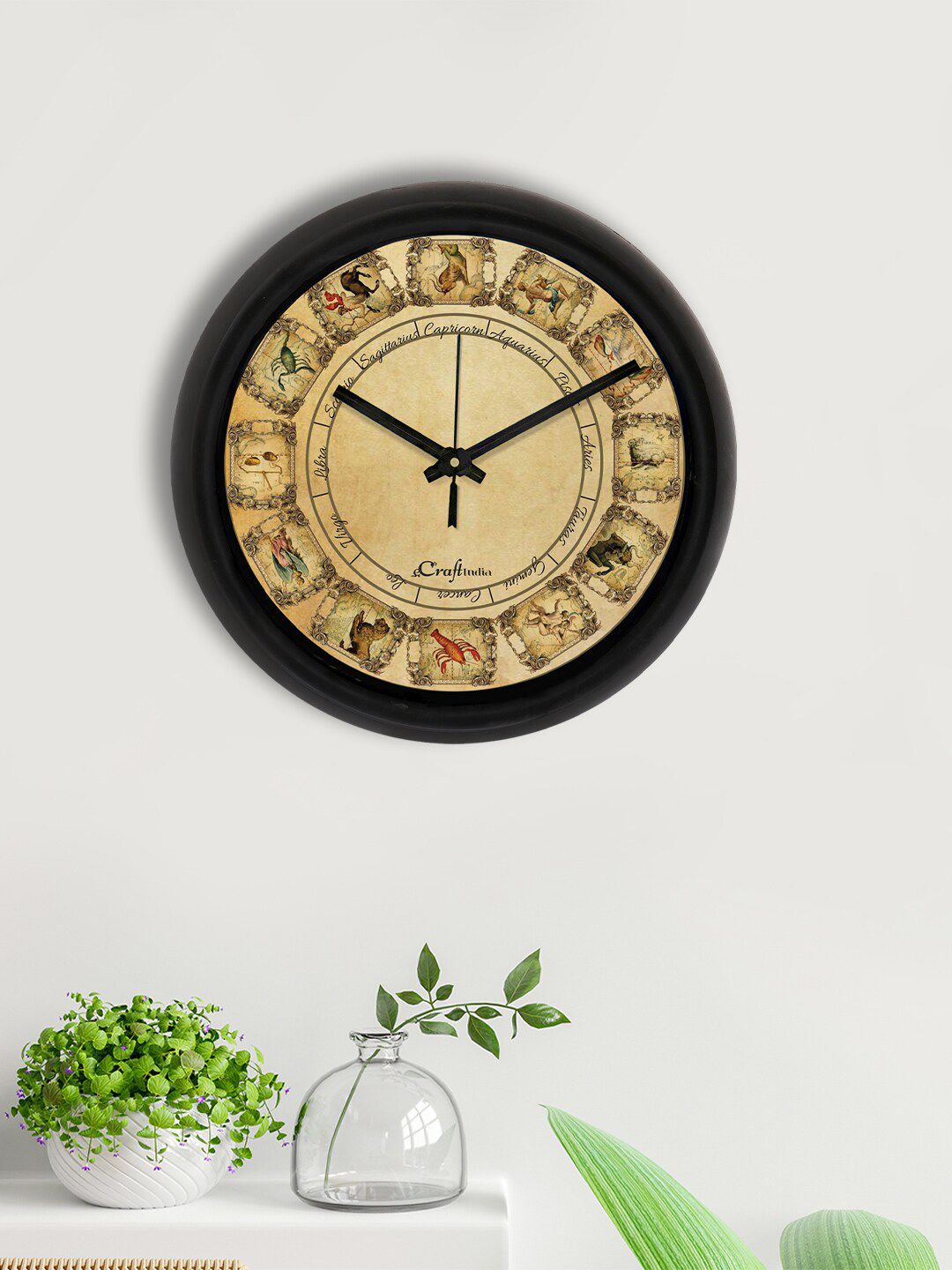 eCraftIndia Black & Beige Zodiac Sign Printed Contemporary Analogue Wall Clock Price in India