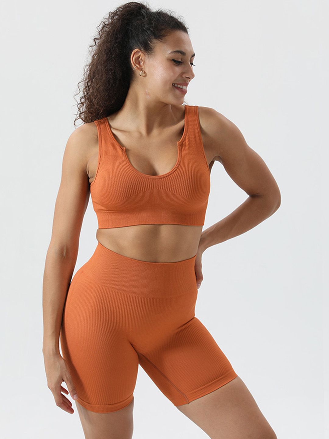URBANIC Women Rust Orange Ribbed Slim-Fit Padded Gym Track Suit Price in India