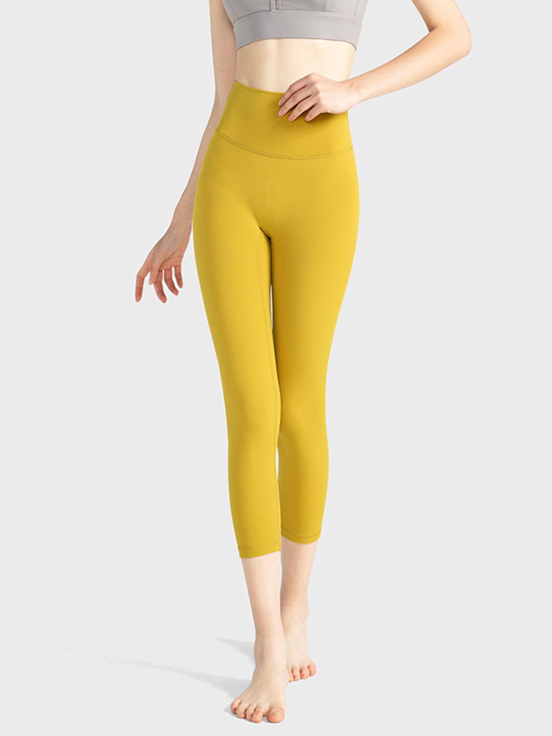 URBANIC Women Mustard Yellow Solid Gym Crop Tights Price in India