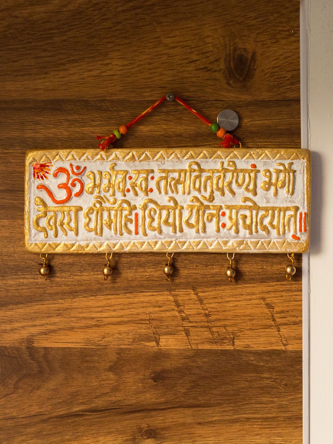 ExclusiveLane Gold-Toned & White Hand-Painted Terracotta Gayatri Mantra Wall Hanging Price in India