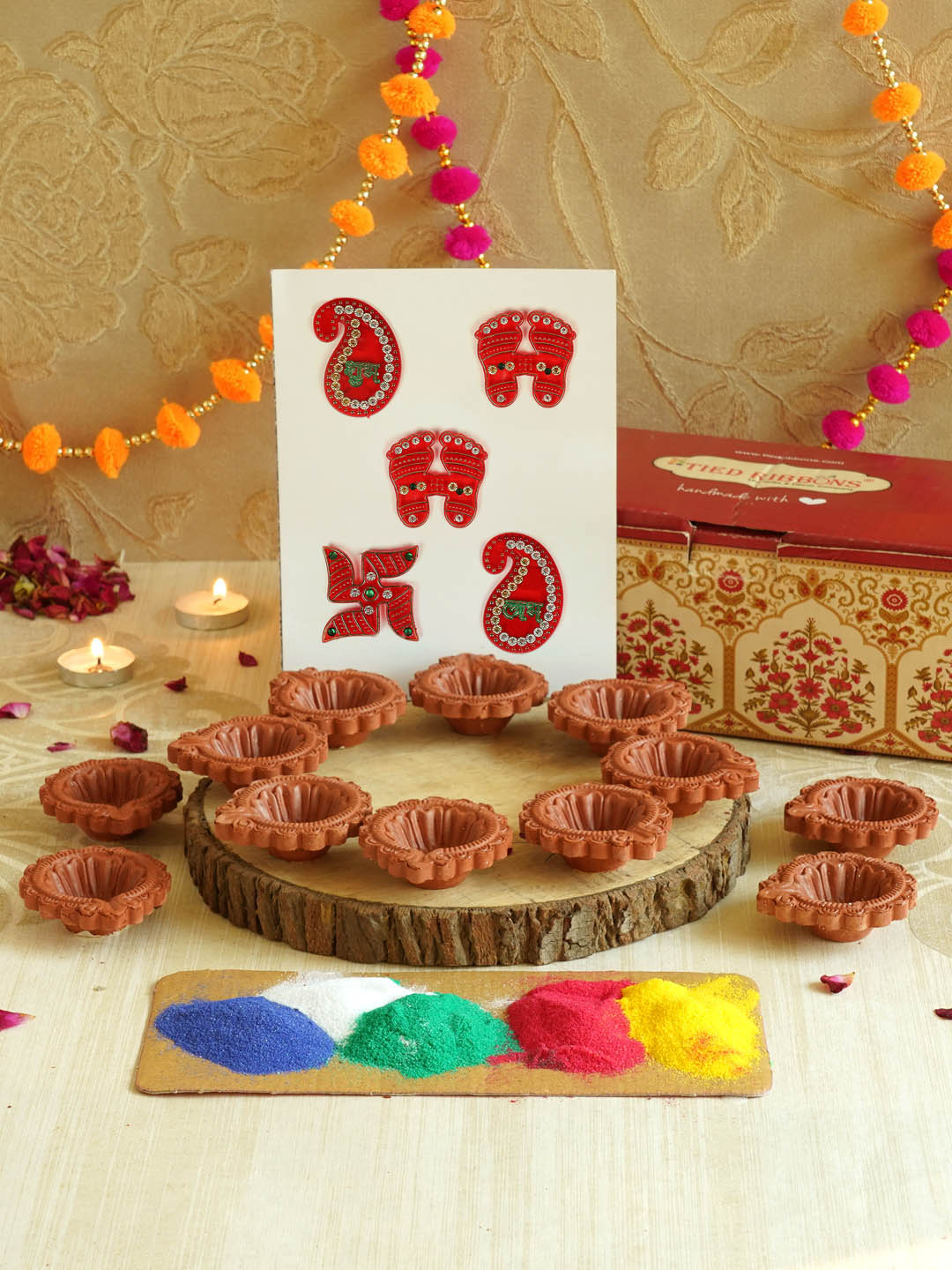 TIED RIBBONS Set of 12 Terracotta Diya with Multi Rangoli Colours & Shubh Labh Stickers Price in India