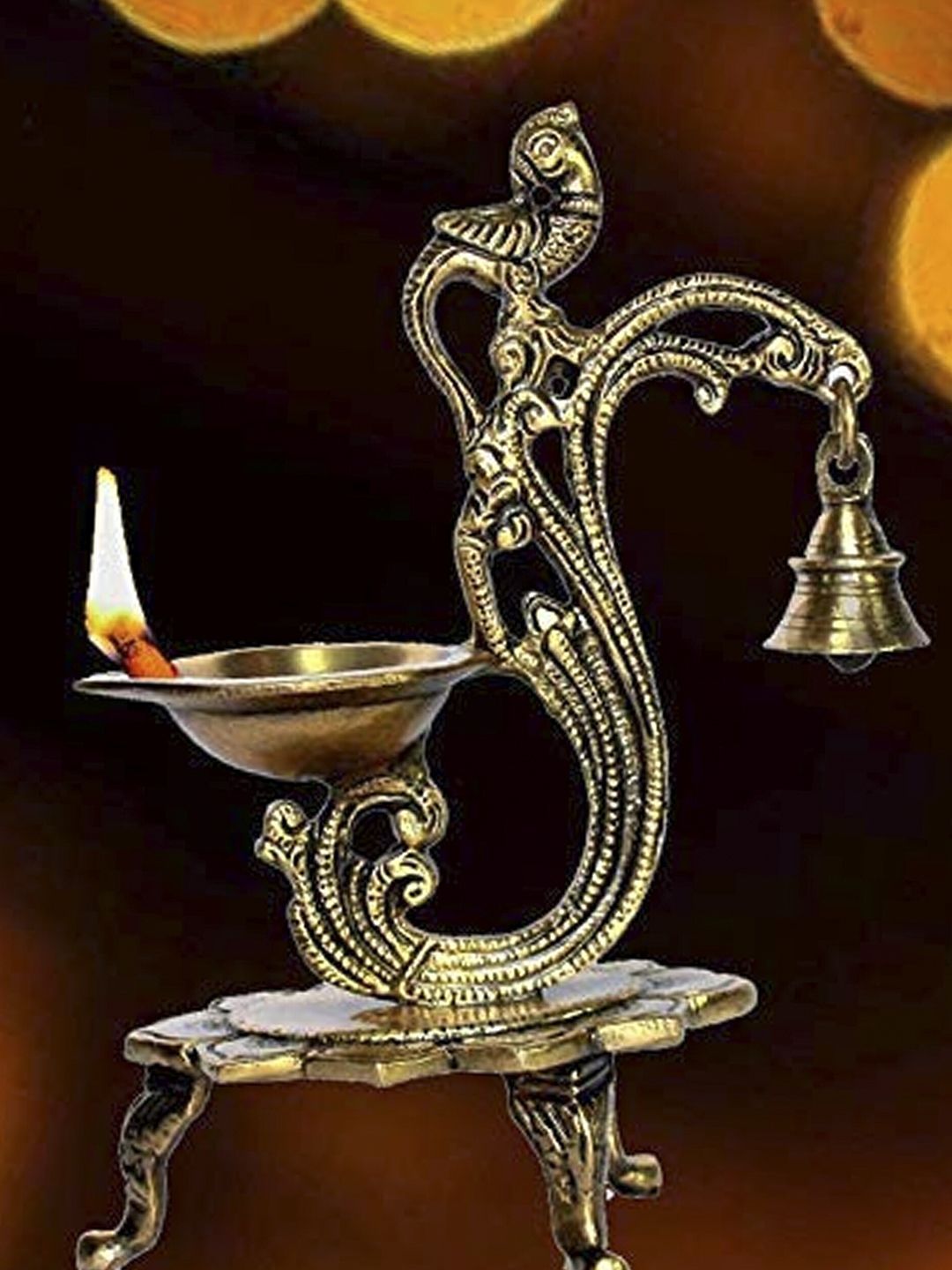 WENS Gold Brass Brass Peacock Diya with Bells in Golden Finish Price in India