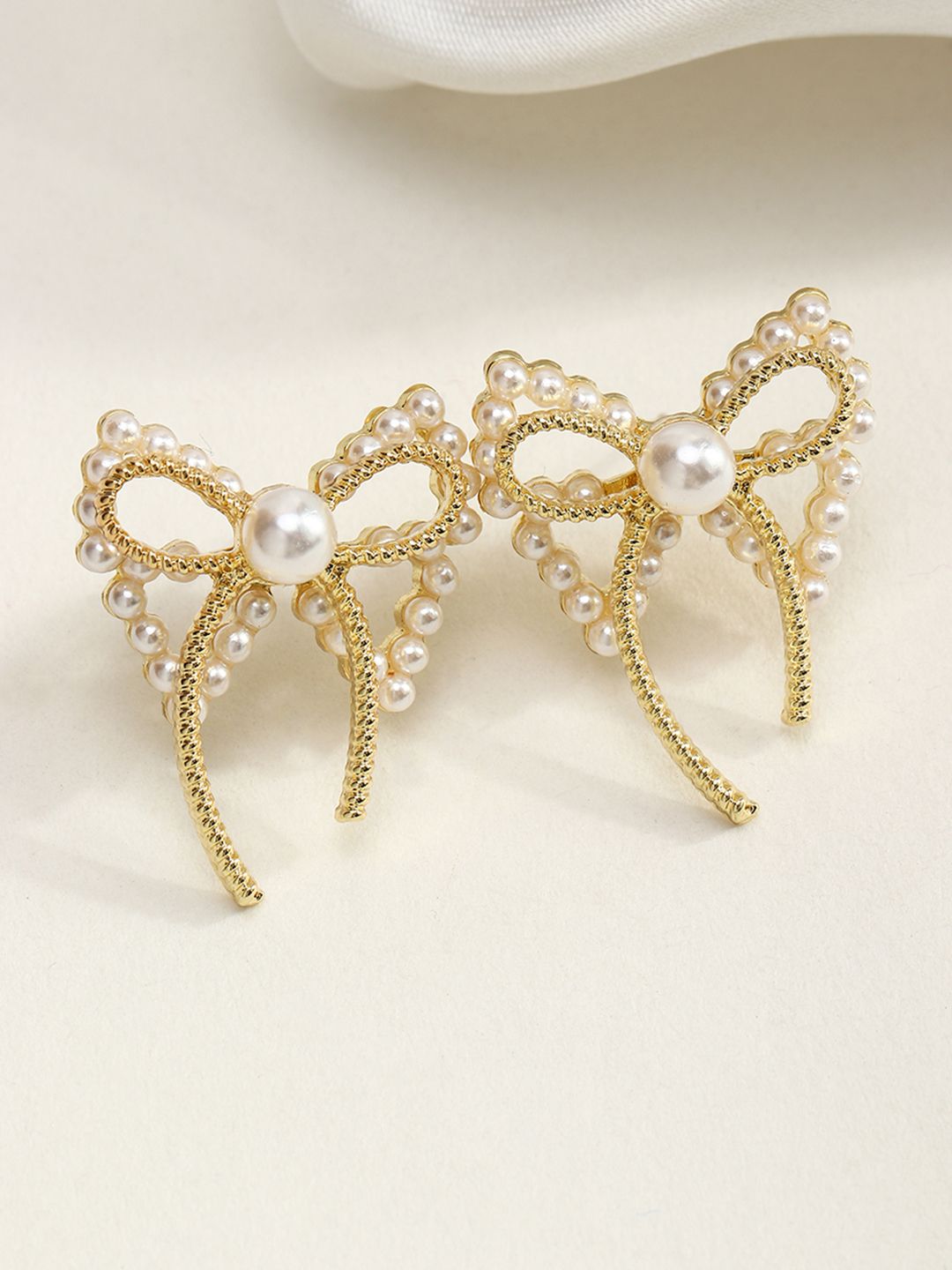 URBANIC Women Gold-Toned & White Bow Tie Imitation Contemporary Studs Earrings Price in India