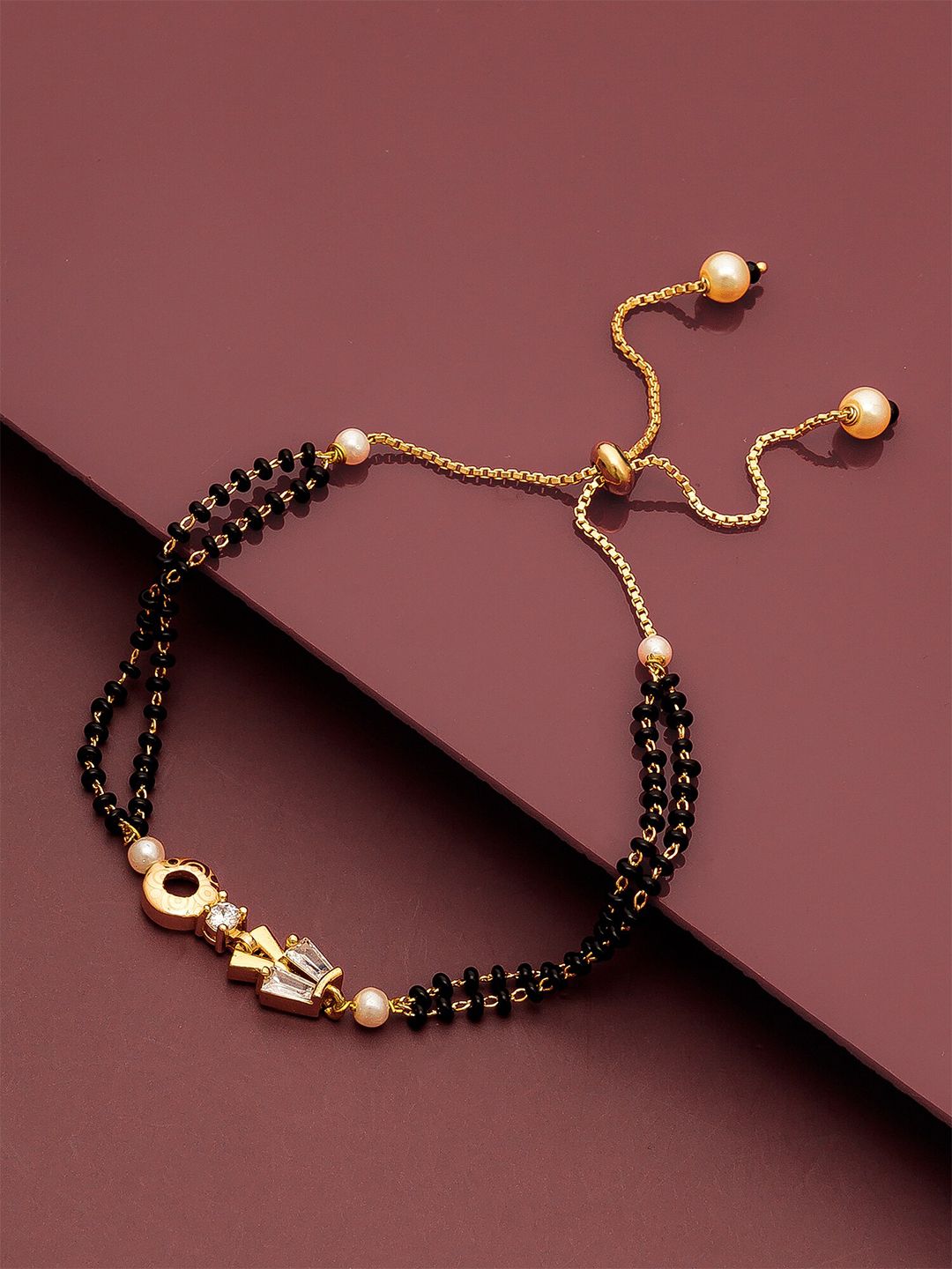 aadita Gold-Toned & Black Brass AD-Studded Gold-Plated Mangalsutra Link Bracelet Price in India
