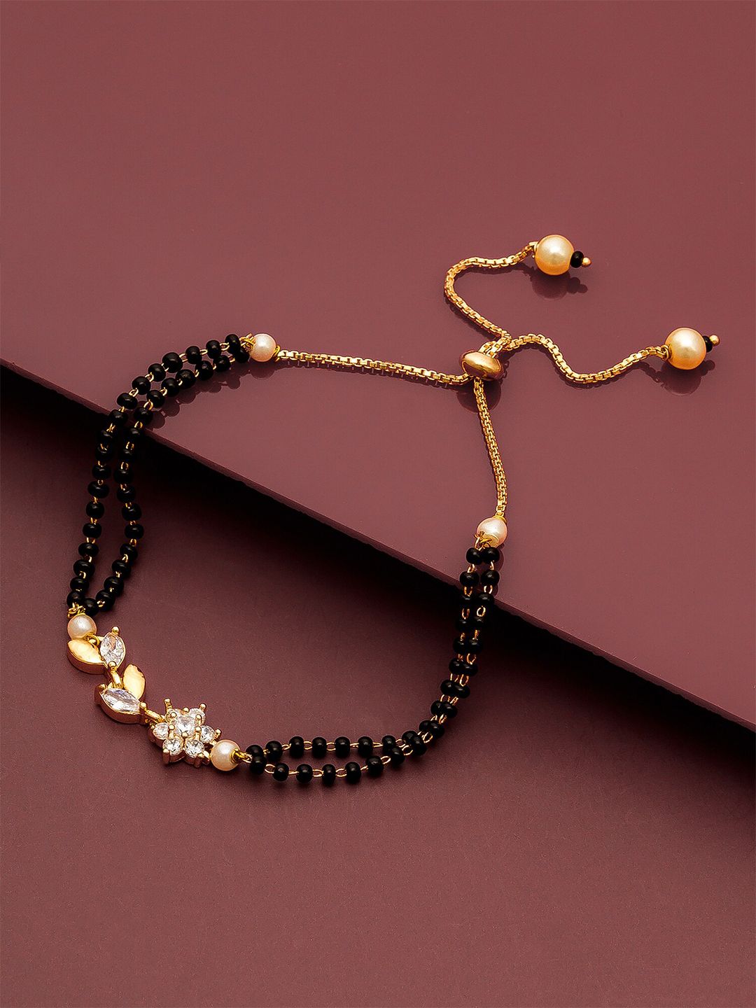 aadita Women Gold-Plated & Black Brass American Diamond Hand Mangalsutra Link Bracelet Price in India