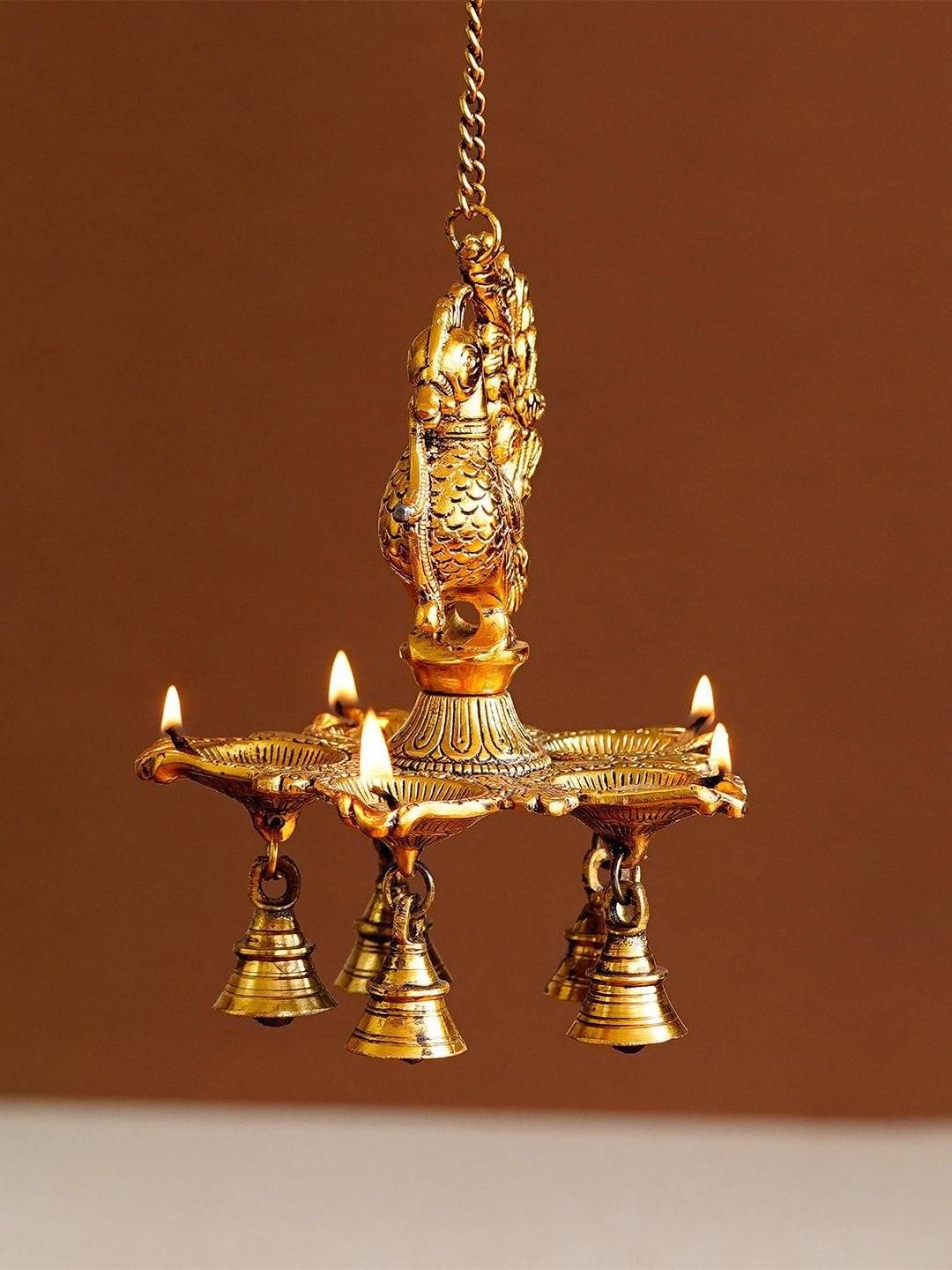 eCraftIndia Gold-Toned Peacock Diya With Bell Handcrafted Wall Hanging With Chain Price in India