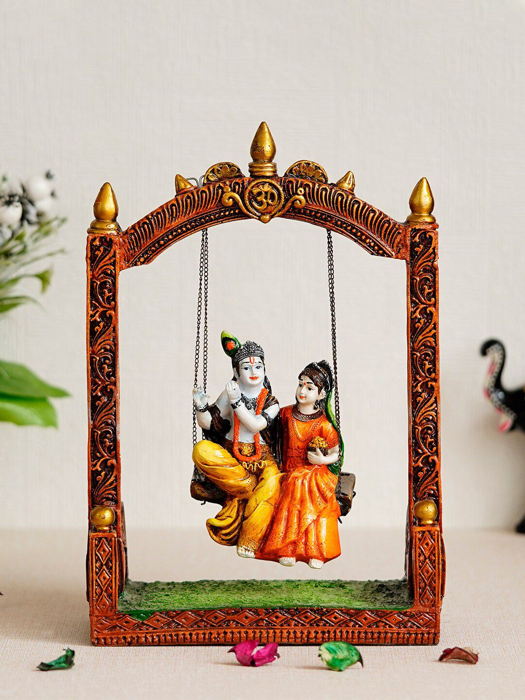 eCraftIndia Orange & White Radha Krishna On Swing Handcrafted Figurine Price in India