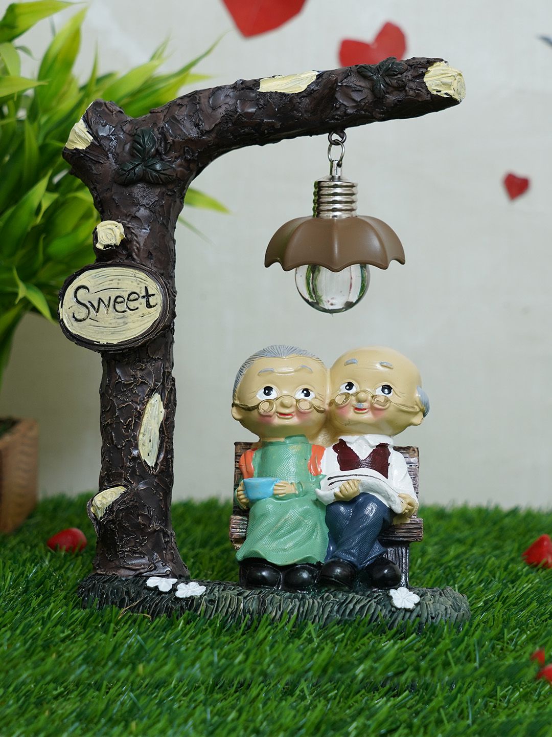 TIED RIBBONS Brown & Beige Old Age Couple LED Light Showpiece Price in India