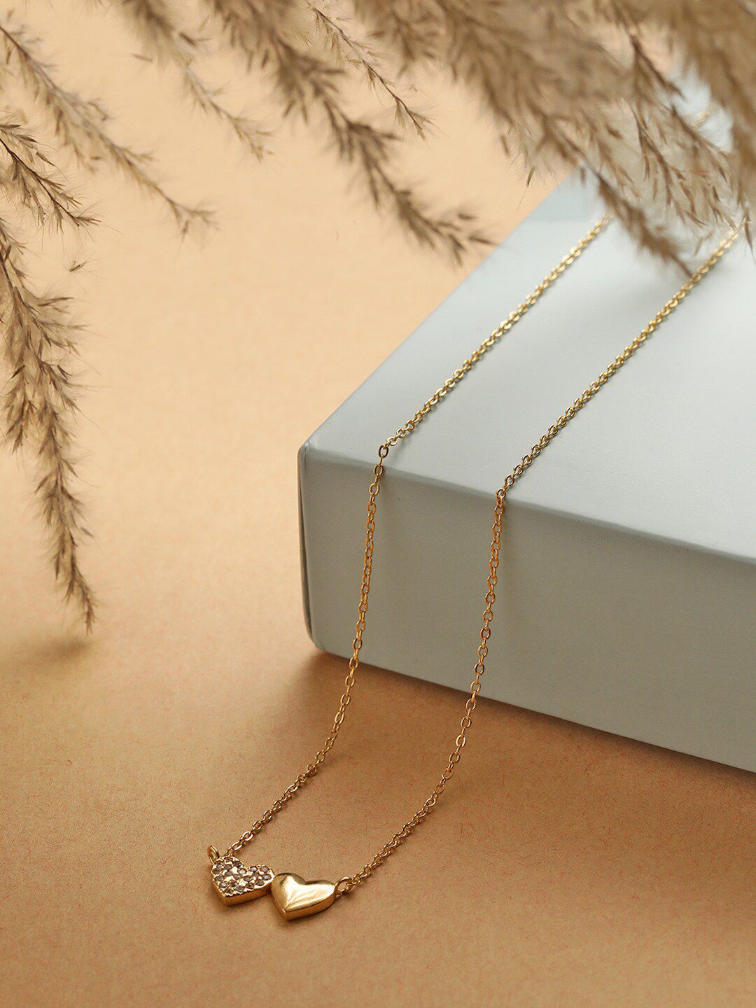 MINUTIAE Women Gold-Toned & White Crystal Studded Twin Heart Chain Necklace Price in India