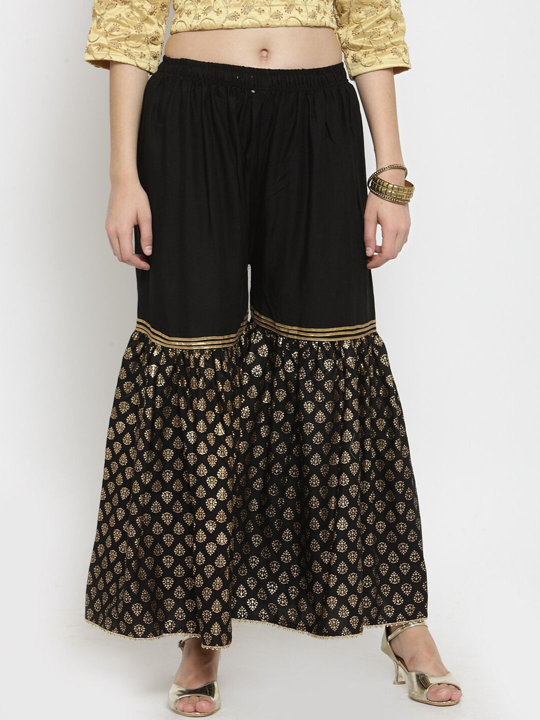 Clora Creation Women Black & Gold-Toned Ethnic Motifs Printed Flared Knitted Palazzos Price in India