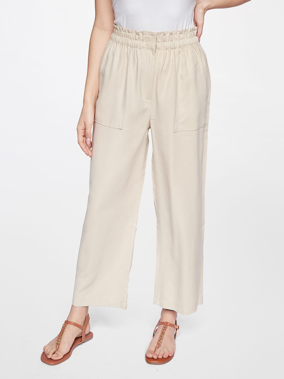 AND Women Cream-Coloured Straight Fit Easy Wash Pleated Trousers Price in India