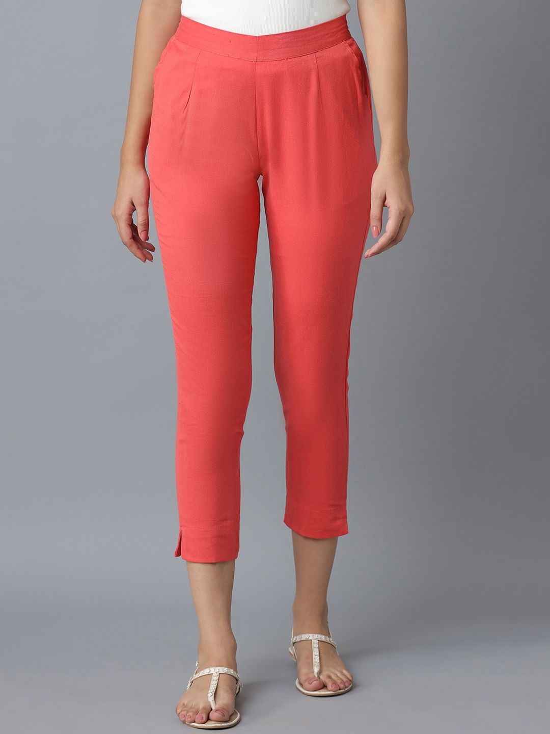 elleven Women Peach-Coloured Solid Tapered Fit Pleated Trousers Price in India