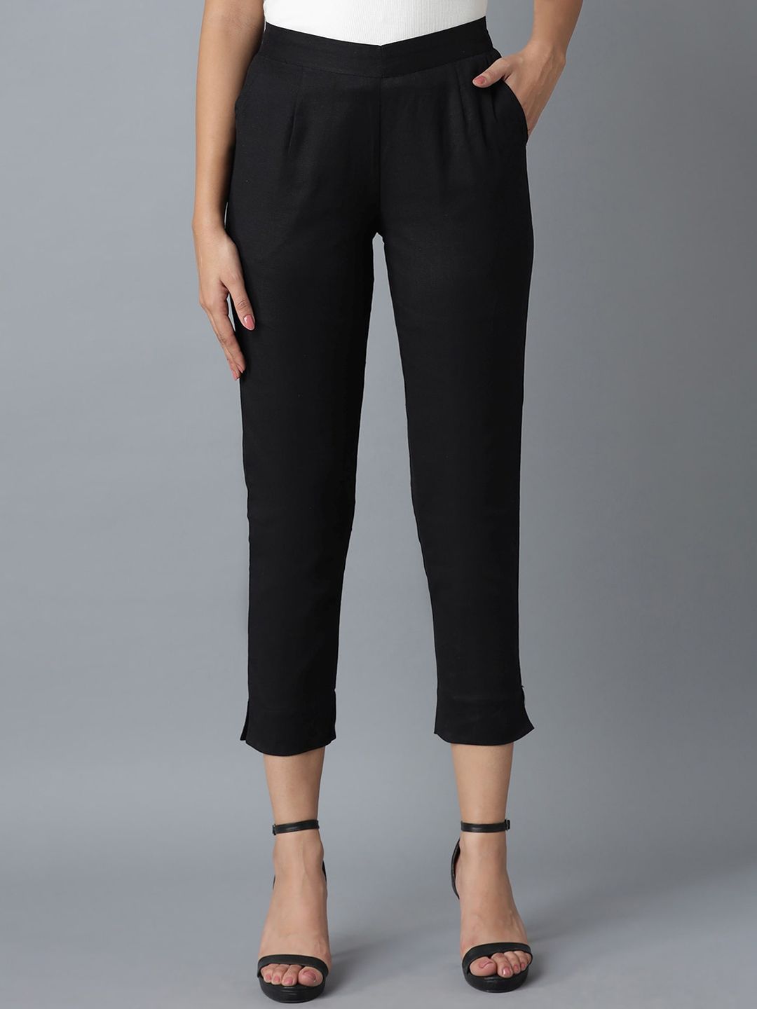 elleven Women Black Solid Tapered Fit Pleated Cigarette Trousers Price in India