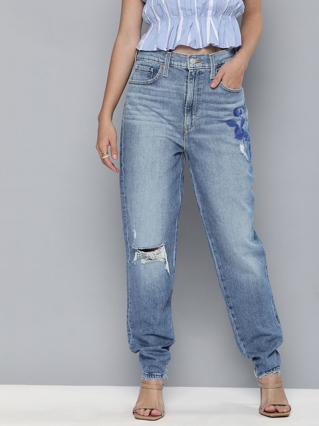 Levis Women Blue Tapered Fit High-Rise Mildly Distressed Light Fade Embroidered Stretchable Jeans Price in India