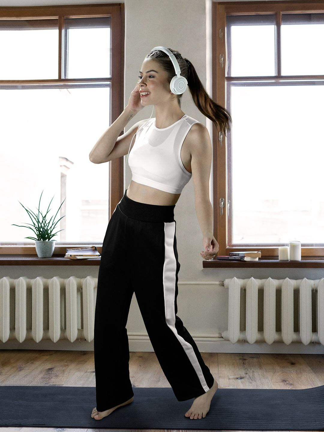 Puma Women Black & White Solid Knitted Mid-Rise T7 Straight Sustainable Sustainable Track Pants with Side Stripes Price in India