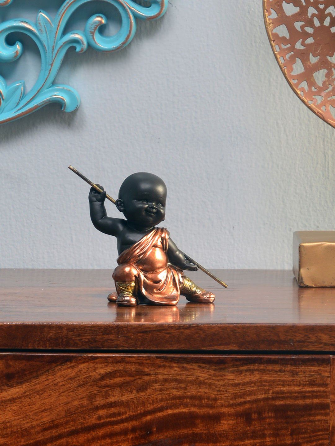 Athome by Nilkamal  Brown Baby Monk Holding Stick Showpiece Price in India