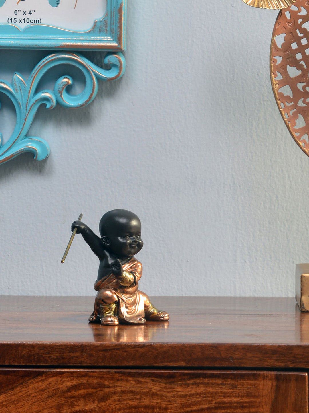 Athome by Nilkamal Copper-Toned & Black Baby Monk Holding Stick Showpiece Price in India