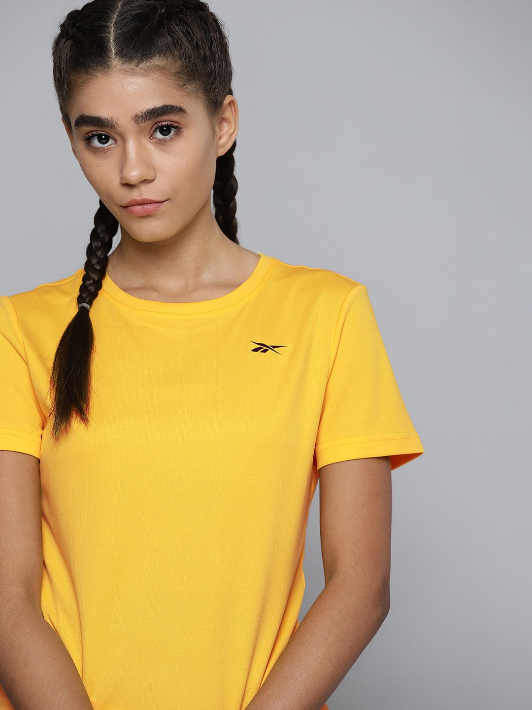 Reebok Women Yellow Solid Training or Gym T-shirt Price in India