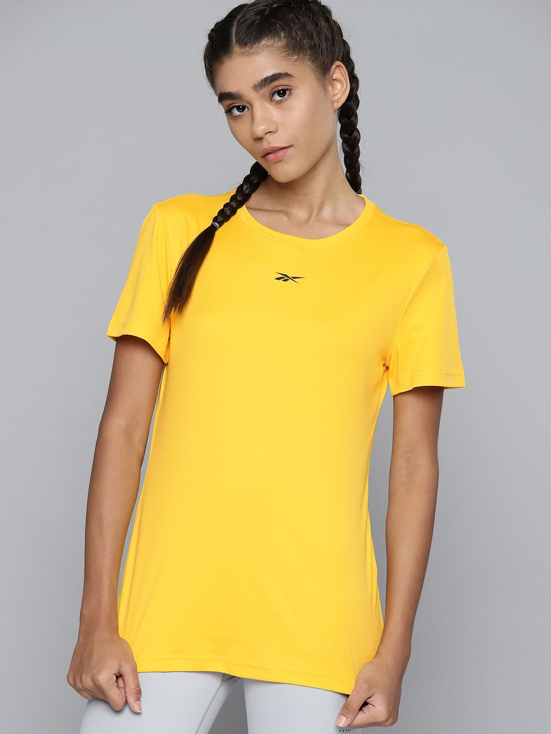 Reebok Women Yellow Solid Training or Gym T-shirt Price in India