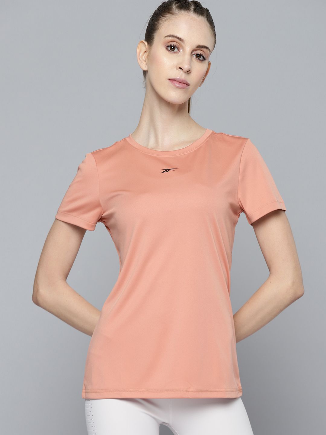 Reebok Women Peach-Coloured Solid CORE POLY  Training T-shirt Price in India