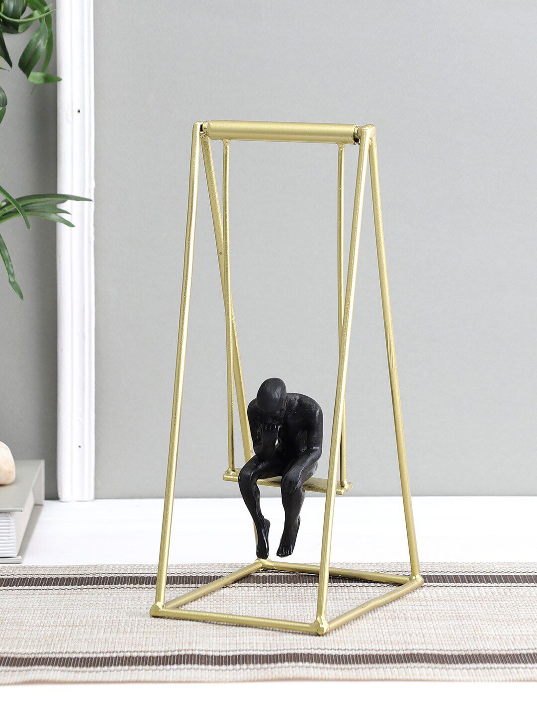 Aapno Rajasthan Gold-Toned & Black Man On Swing Showpiece Price in India
