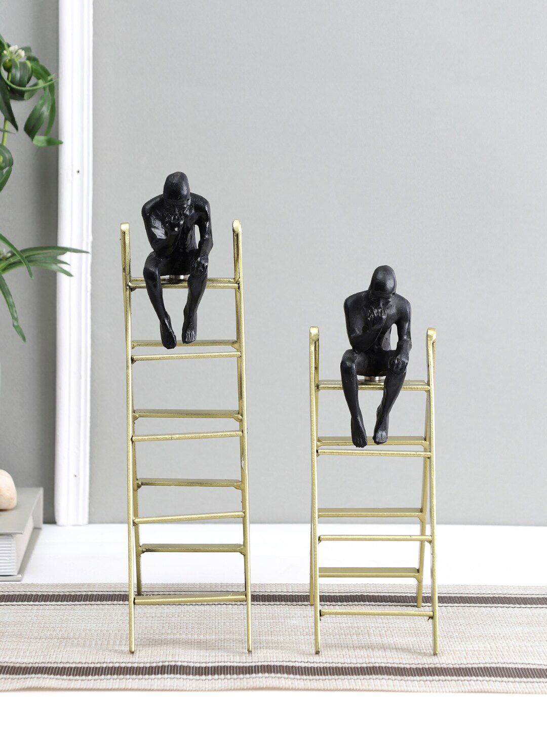 Aapno Rajasthan Set Of 2 Gold-Toned & Black Simple Ladder Showpieces Price in India