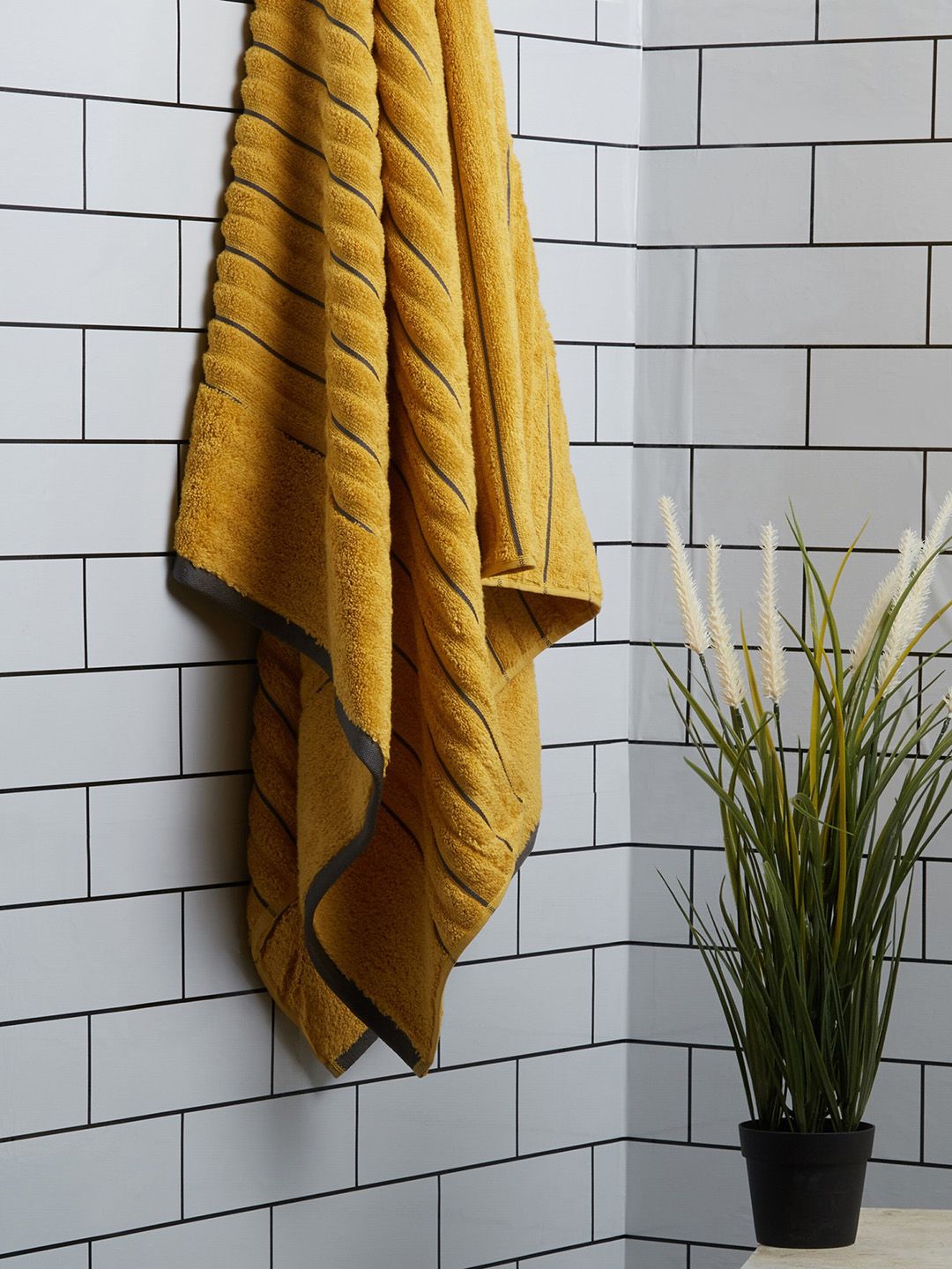 SPACES Mustard Yellow Solid 580 GSM Pure Cotton Towel Price in India