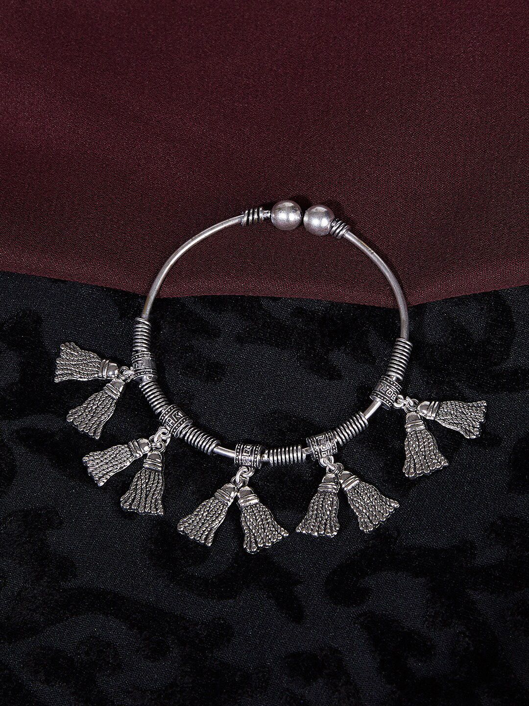 ZeroKaata Women Silver-Toned Oxidized Tribal Broom Charm Bangle-Style Bracelet Price in India