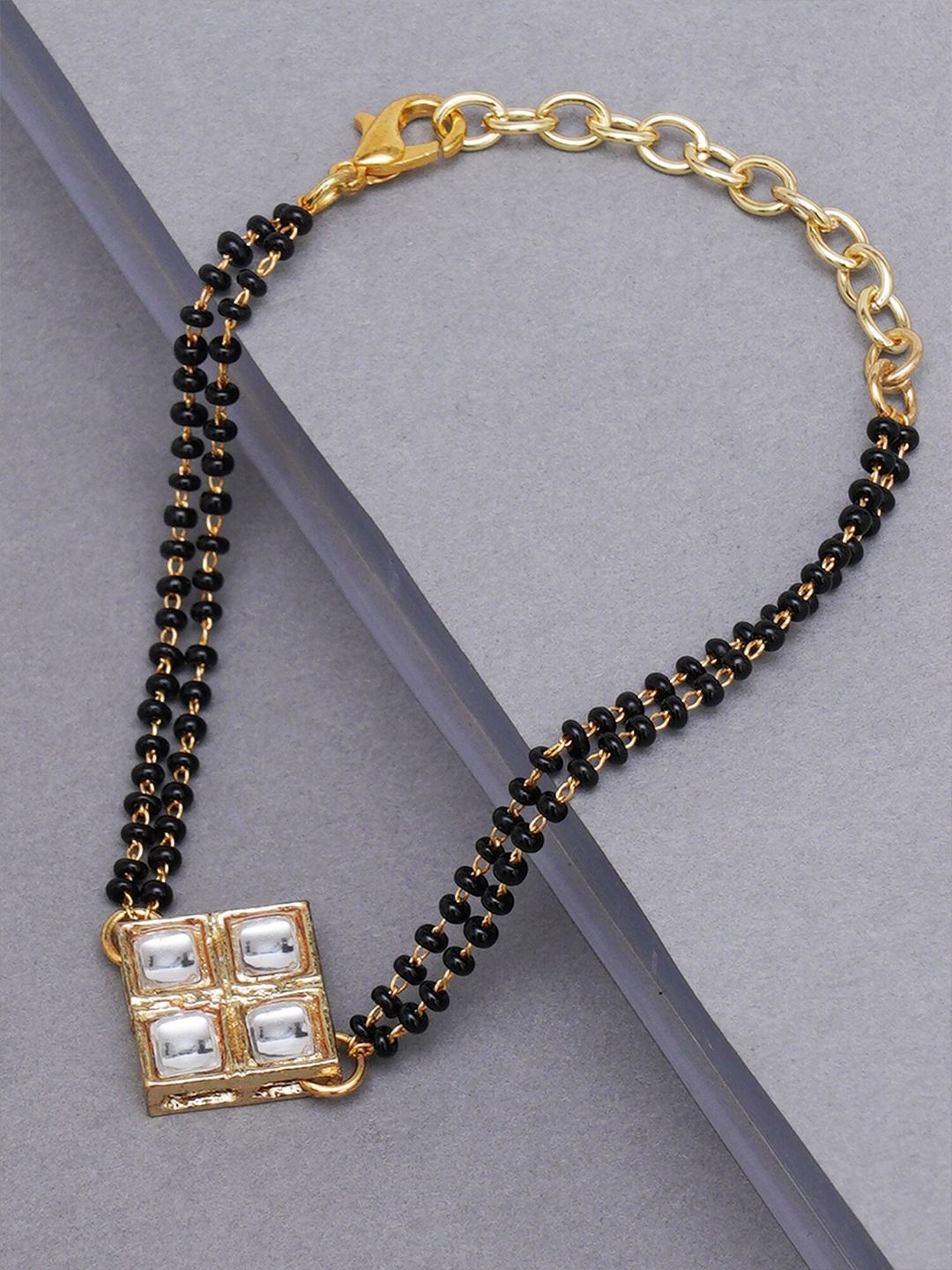 KARATCART Women Gold-Plated & Black Charm Bracelet Price in India