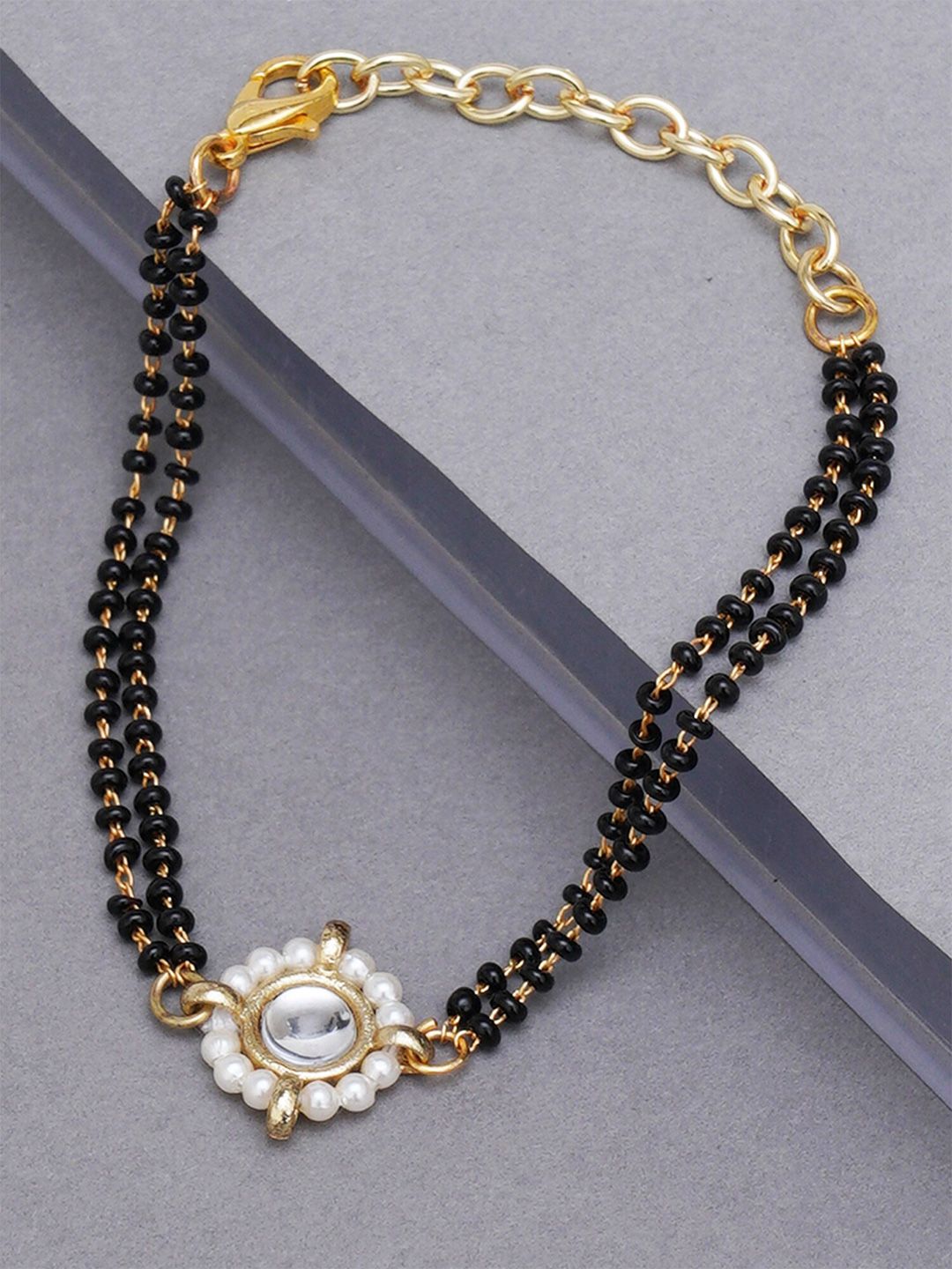 KARATCART Women Gold-Toned & Black Kundan Gold-Plated Charm Bracelet Price in India