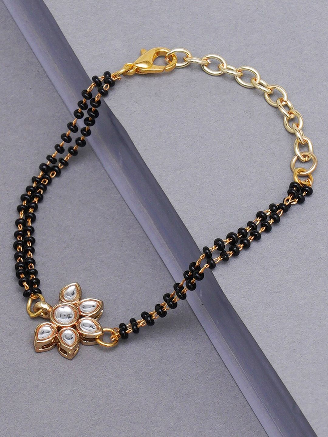 KARATCART Women Gold-Toned & Black Kundan Handcrafted Gold-Plated Charm Bracelet Price in India