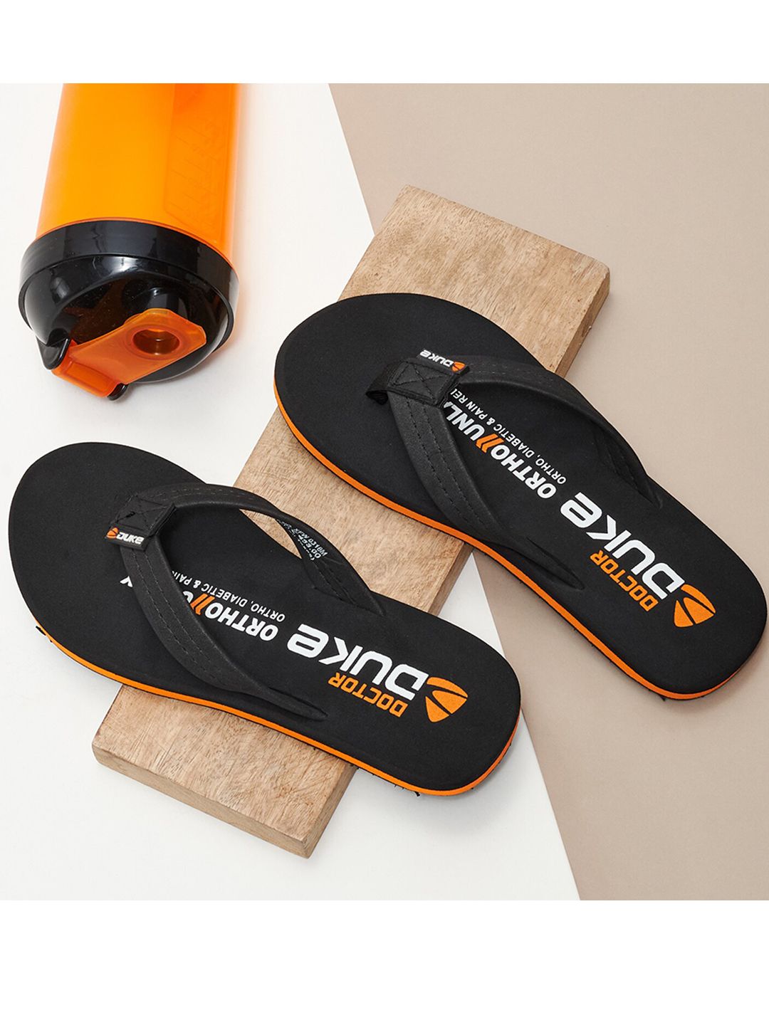Duke Women Black & Orange Printed Thong Flip-Flops Price in India